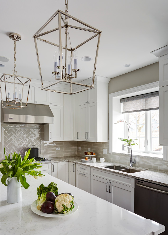Inspiration for a large transitional u-shaped medium tone wood floor open concept kitchen remodel in Chicago with a double-bowl sink, flat-panel cabinets, white cabinets, quartz countertops, beige backsplash, subway tile backsplash, stainless steel appliances and an island