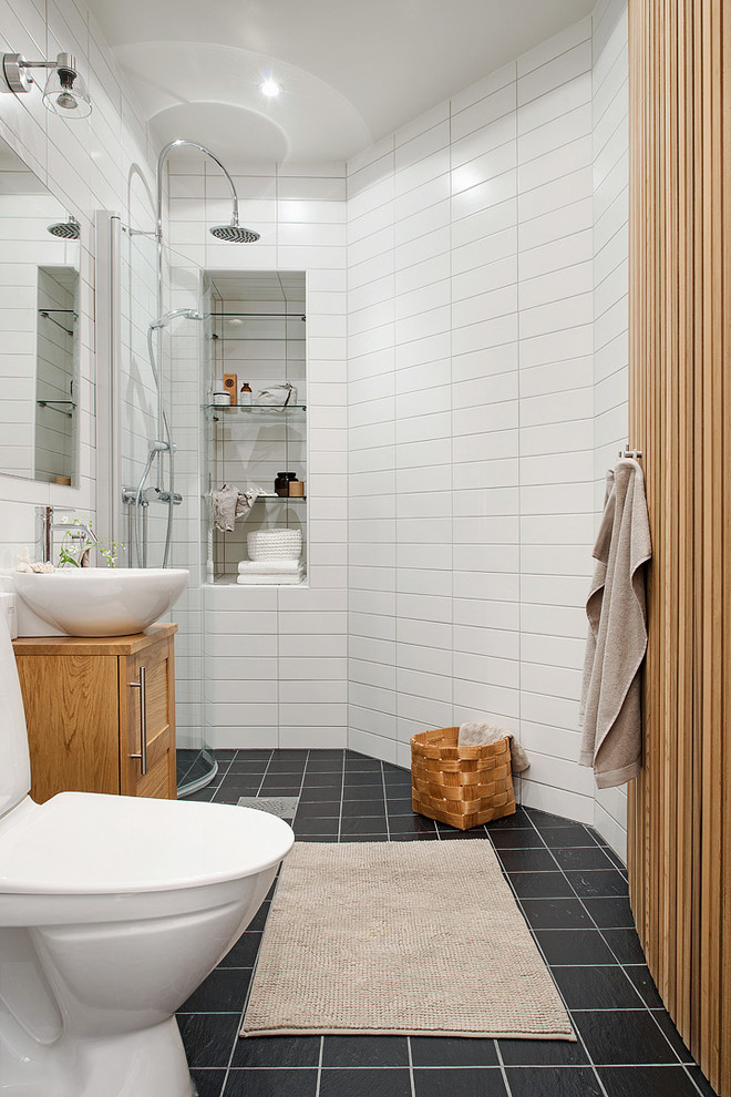 Mid-sized contemporary bathroom in Gothenburg with recessed-panel cabinets, medium wood cabinets, an open shower, a two-piece toilet, subway tile, white walls, ceramic floors, a vessel sink, wood benchtops and an open shower.