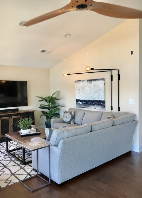 Mid-sized transitional open concept medium tone wood floor and brown floor living room photo in Charlotte with yellow walls