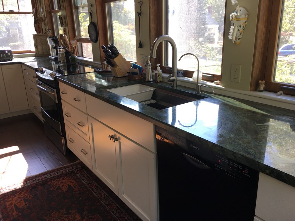 Transitional u-shaped dark wood floor kitchen photo in Boston with an undermount sink, shaker cabinets, white cabinets, granite countertops and stainless steel appliances