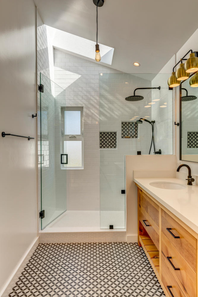 Design ideas for a mid-sized contemporary master bathroom in Los Angeles with flat-panel cabinets, medium wood cabinets, white tile, ceramic tile, porcelain floors, an undermount sink, engineered quartz benchtops, black floor, a hinged shower door, white benchtops, a double vanity and a freestanding vanity.