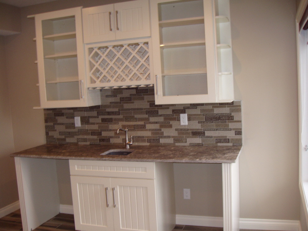 Example of a transitional home bar design in Calgary