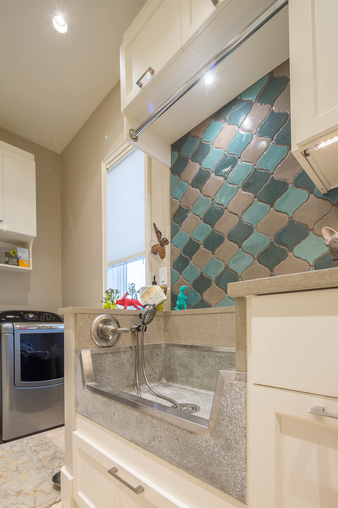 Large modern galley utility room in Austin with an utility sink, shaker cabinets, white cabinets, quartz benchtops, beige walls and a side-by-side washer and dryer.