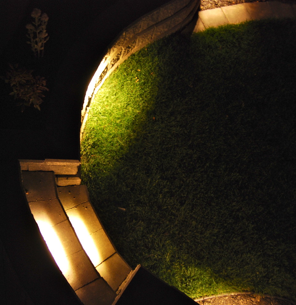 Inspiration for a mid-sized rustic backyard concrete paver landscaping in Calgary.