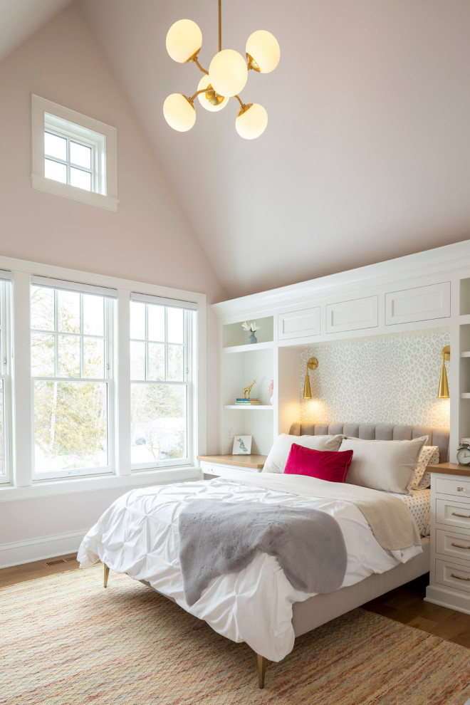 This is an example of a large traditional kids' room for girls in Minneapolis with pink walls, medium hardwood floors and vaulted.