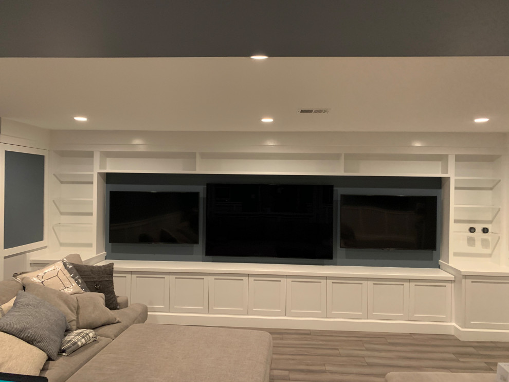 Basement - large cottage walk-out laminate floor, gray floor and wall paneling basement idea in DC Metro with a home theater, gray walls and no fireplace