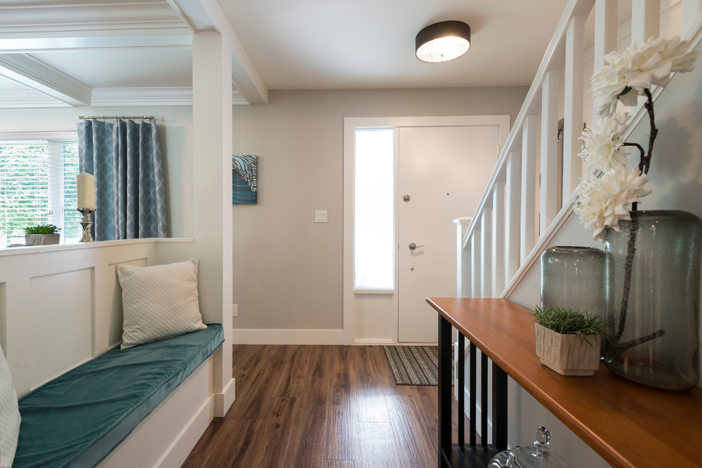 Mid-sized transitional medium tone wood floor front door photo in Vancouver with gray walls and a white front door