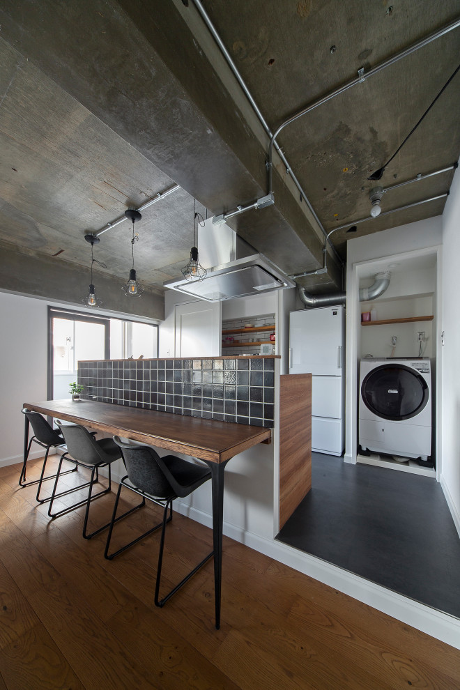 Photo of a small industrial single-wall open plan kitchen in Kyoto with an undermount sink, beaded inset cabinets, medium wood cabinets, stainless steel benchtops, ceramic floors and with island.