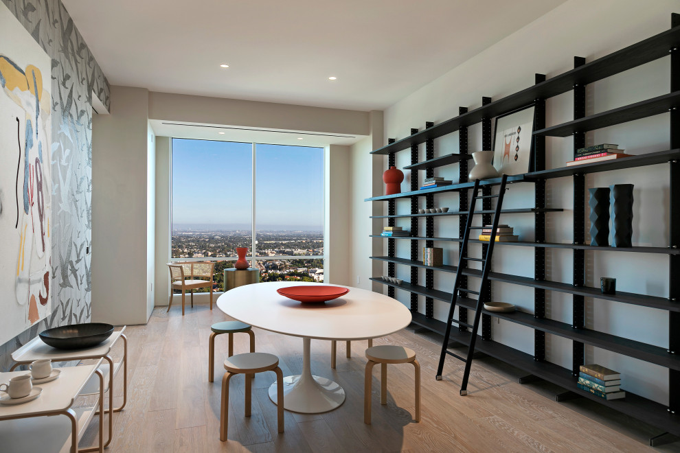 Photo of a contemporary dining room in Los Angeles with white walls, light hardwood flooring and beige floors.