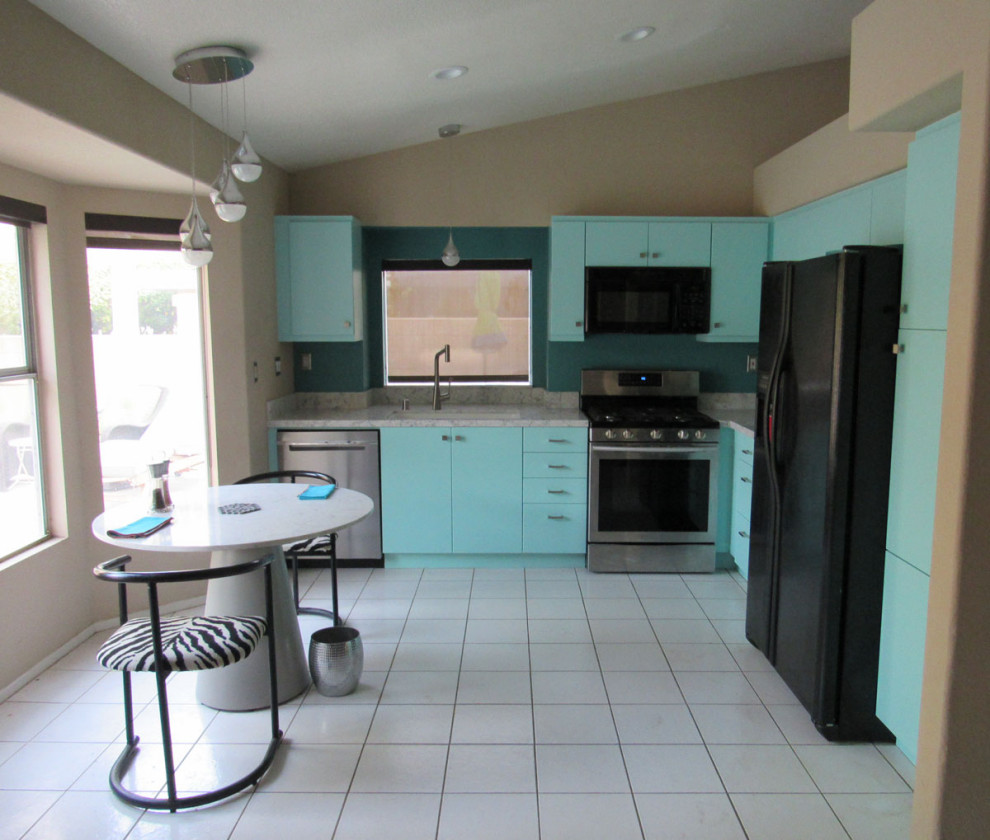 Photo of a small midcentury l-shaped eat-in kitchen in Los Angeles with an undermount sink, flat-panel cabinets, turquoise cabinets, quartz benchtops, grey splashback, engineered quartz splashback, stainless steel appliances, porcelain floors, no island, white floor, grey benchtop and vaulted.