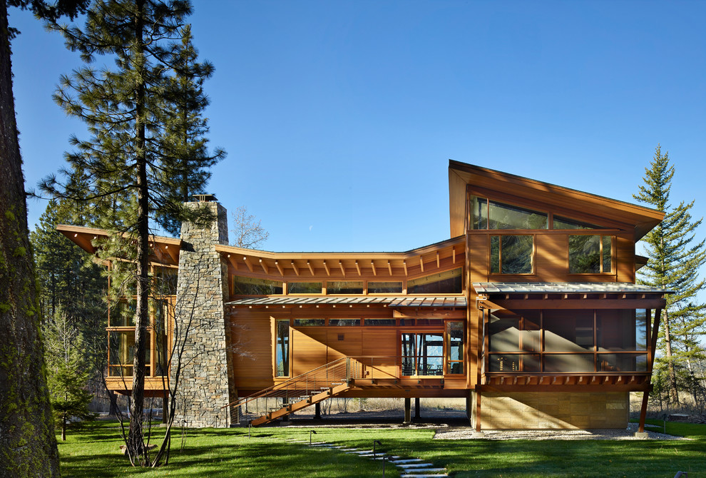 This is an example of a large contemporary two-storey brown exterior in Seattle with wood siding and a shed roof.