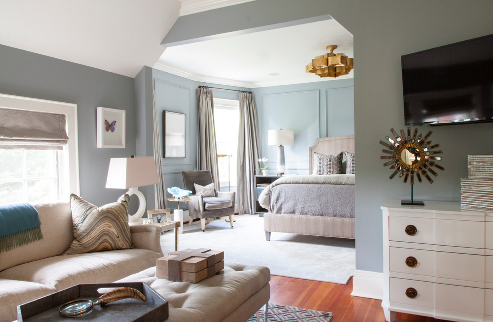 Design ideas for a transitional master bedroom in New York with blue walls, medium hardwood floors and orange floor.