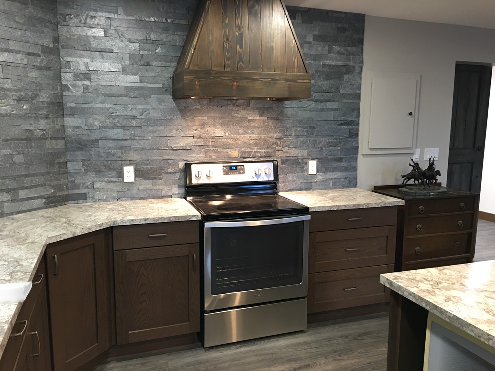 Inspiration for a large rustic galley vinyl floor and gray floor open concept kitchen remodel in Edmonton with a double-bowl sink, shaker cabinets, brown cabinets, laminate countertops, gray backsplash, stone tile backsplash, stainless steel appliances and an island
