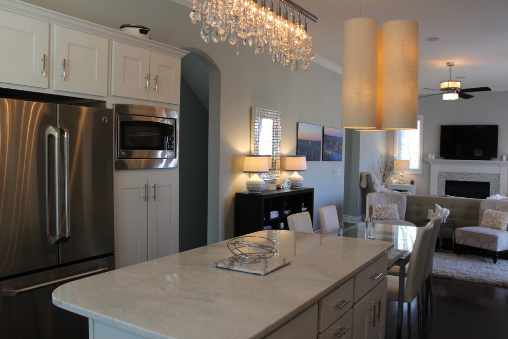 Inspiration for a mid-sized transitional u-shaped dark wood floor open concept kitchen remodel in Cedar Rapids with a single-bowl sink, shaker cabinets, white cabinets, marble countertops, multicolored backsplash, stainless steel appliances, gray walls and an island