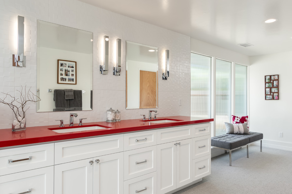 This is an example of a large midcentury master bathroom in San Diego with recessed-panel cabinets, white cabinets, a corner shower, a two-piece toilet, white tile, ceramic tile, white walls, an undermount sink, granite benchtops, beige floor, an open shower and red benchtops.
