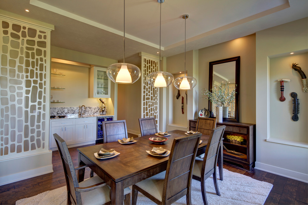 Design ideas for a transitional dining room in Omaha with beige walls and dark hardwood floors.