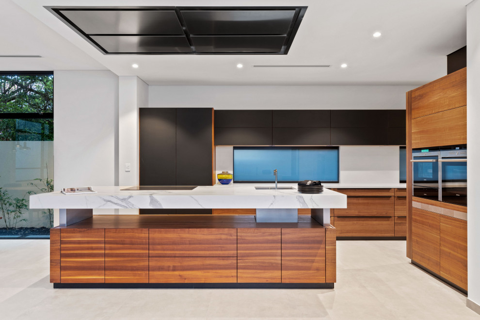 Design ideas for a contemporary kitchen in Perth with an undermount sink, flat-panel cabinets, black cabinets, with island, beige floor and white benchtop.