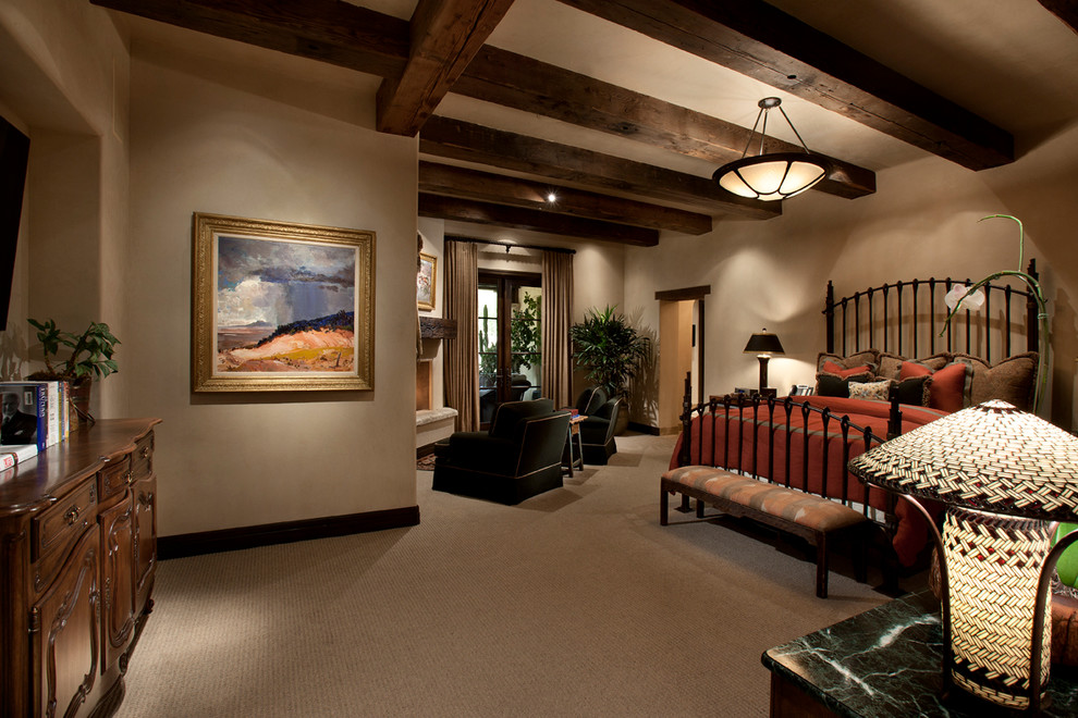 Photo of a large country master bedroom in Phoenix with beige walls, carpet, a corner fireplace and a plaster fireplace surround.