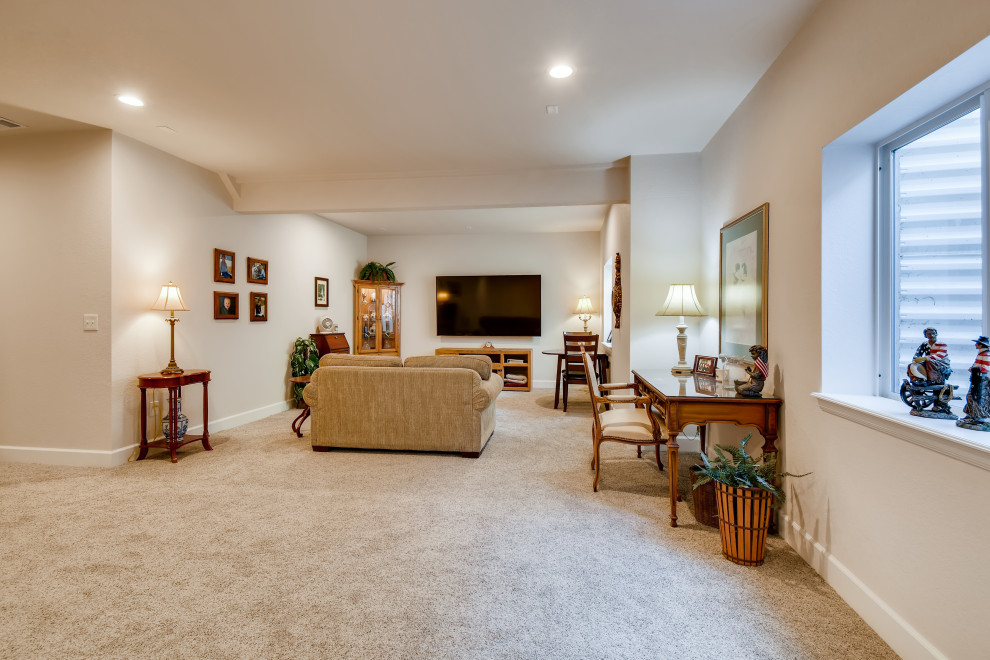 This is an example of a small transitional look-out basement in Denver with beige walls, carpet and beige floor.