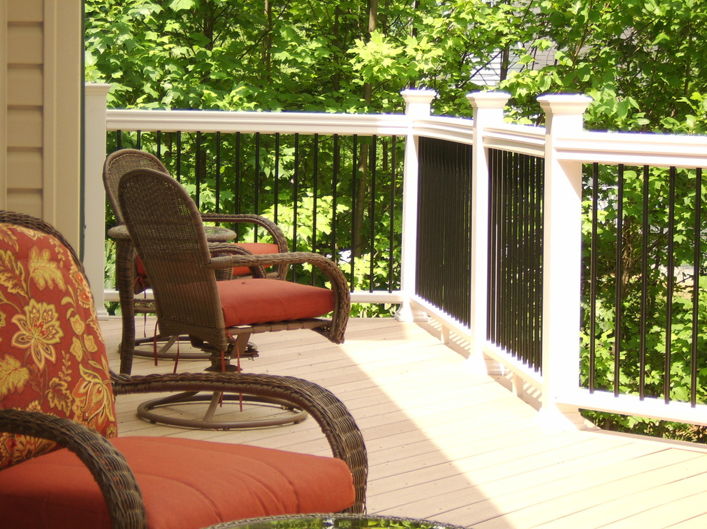 Example of a large transitional backyard deck design in DC Metro with a roof extension
