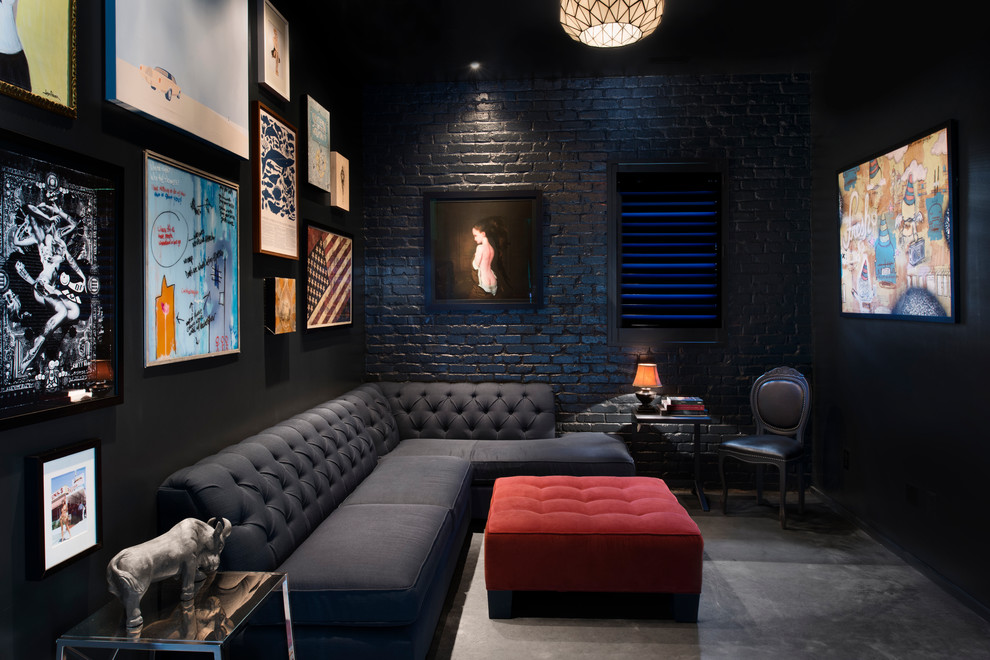 Inspiration for a contemporary enclosed home theatre in Atlanta with black walls, concrete floors, grey floor and a wall-mounted tv.