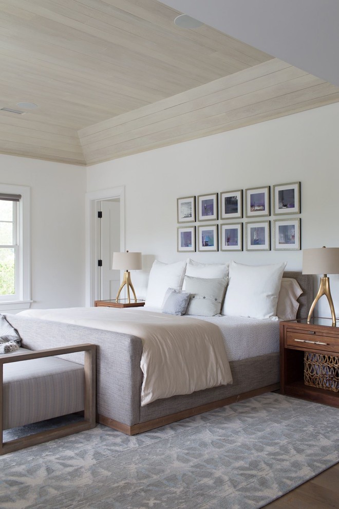 Design ideas for a large transitional master bedroom in Other with white walls, medium hardwood floors and brown floor.