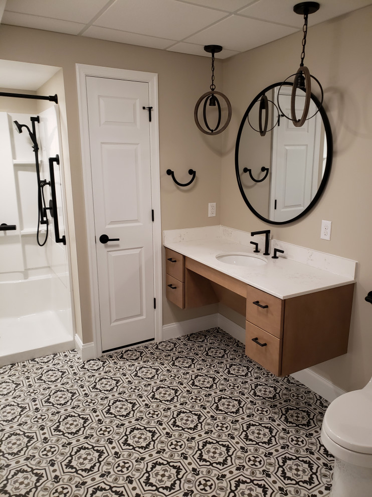 Photo of a small industrial bathroom in Philadelphia with flat-panel cabinets, light wood cabinets, an alcove shower, beige walls, porcelain floors, an undermount sink, multi-coloured floor, an open shower, white benchtops, a shower seat, a single vanity and a floating vanity.