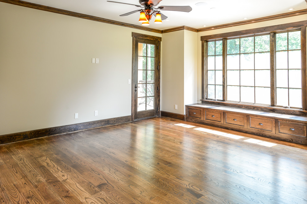 Bedroom - large rustic master dark wood floor and brown floor bedroom idea with beige walls and no fireplace