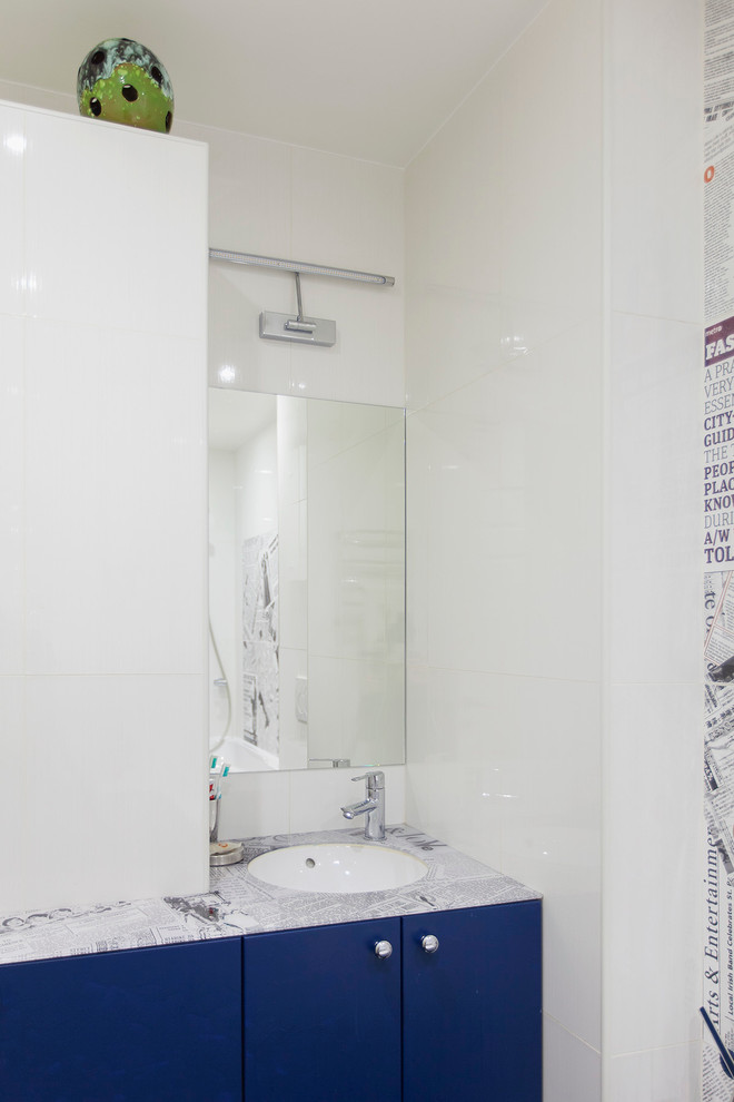 Photo of a contemporary bathroom in Moscow with white tile, flat-panel cabinets, blue cabinets and an undermount sink.