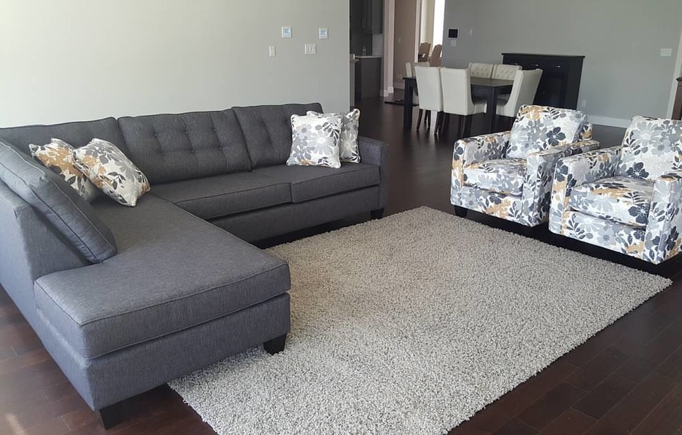 This is an example of a mid-sized transitional formal open concept living room in Calgary with grey walls, dark hardwood floors, no fireplace, no tv and brown floor.