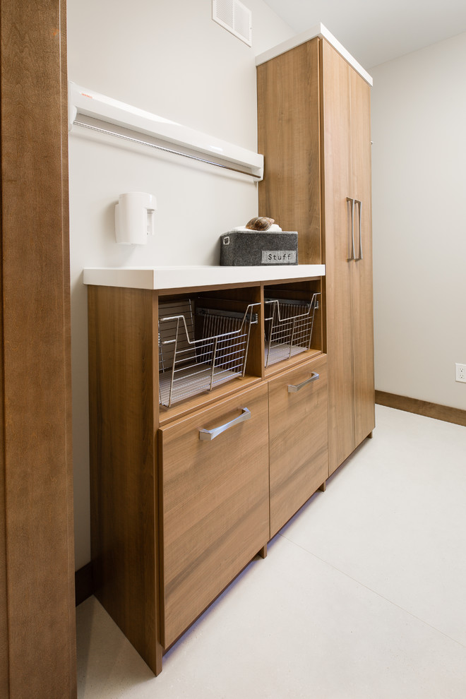 Design ideas for a contemporary galley laundry room in Other with medium wood cabinets, white walls and a side-by-side washer and dryer.