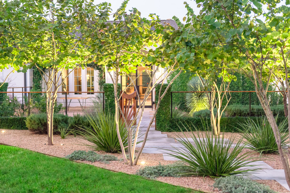 Mid-sized contemporary courtyard full sun formal garden in Austin with a garden path and natural stone pavers for spring.