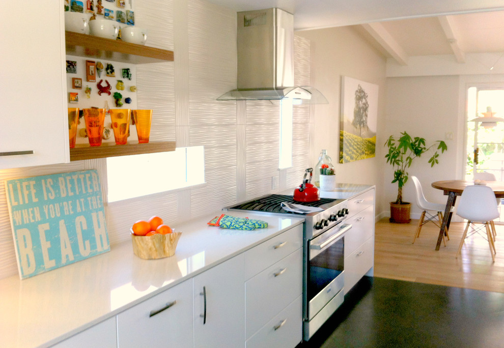This is an example of a small modern galley eat-in kitchen in Los Angeles with a farmhouse sink, flat-panel cabinets, white cabinets, quartz benchtops, white splashback, porcelain splashback, stainless steel appliances and no island.