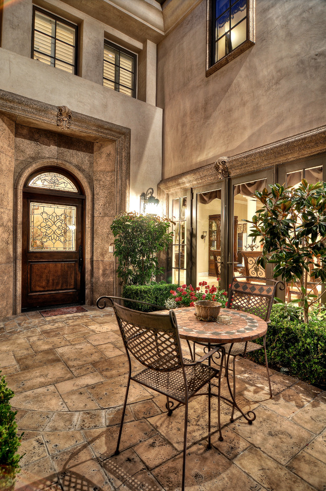 Photo of a mediterranean patio in Los Angeles with natural stone pavers and no cover.