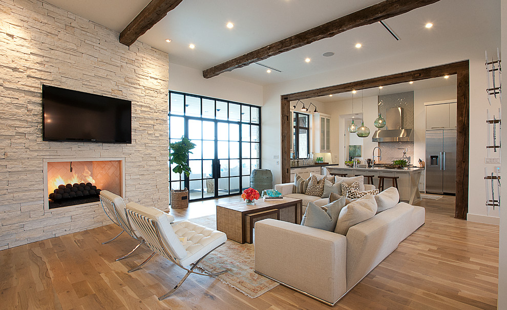 Inspiration for a transitional open concept living room in Austin with a wall-mounted tv and beige floor.