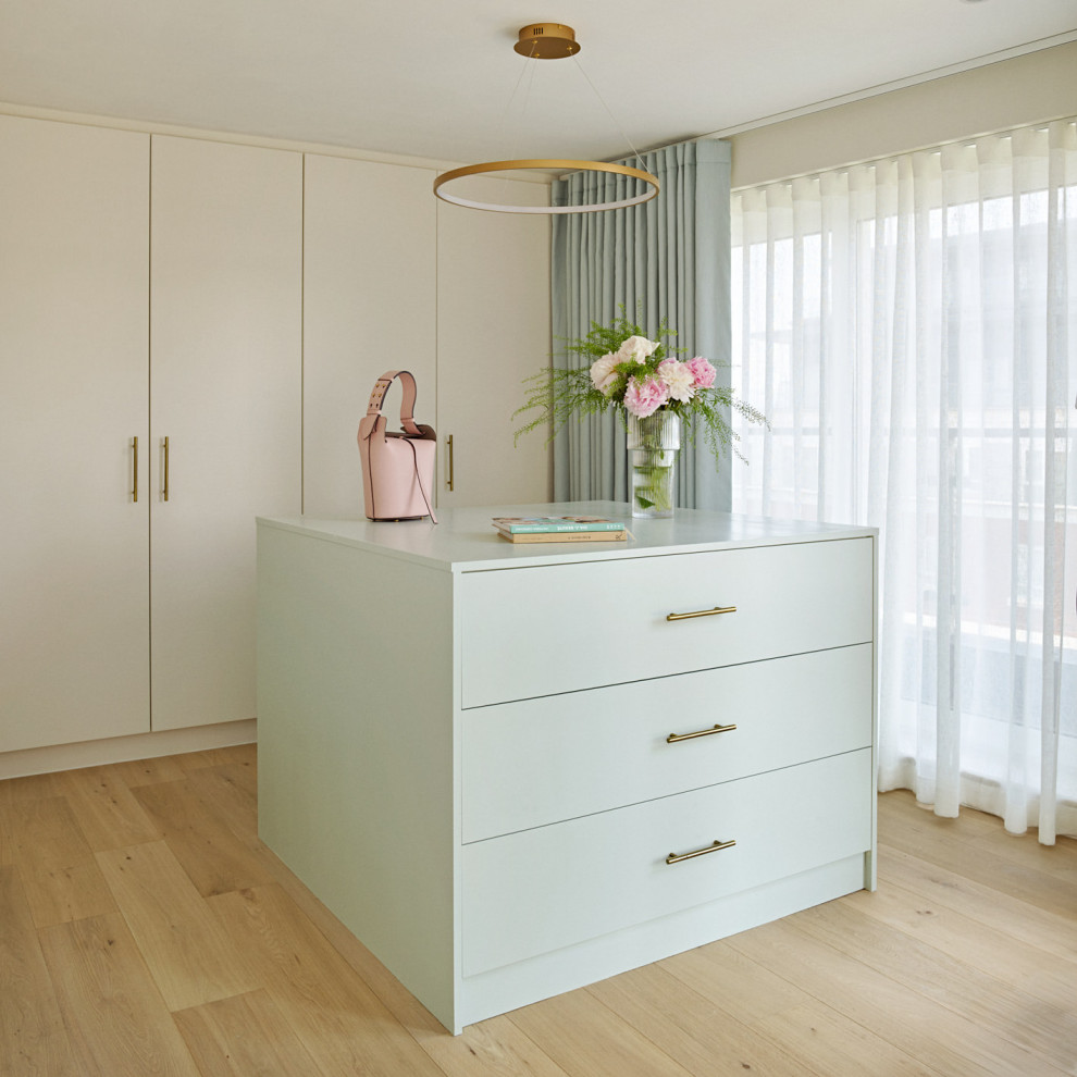 Large contemporary wardrobe for women in London with flat-panel cabinets.