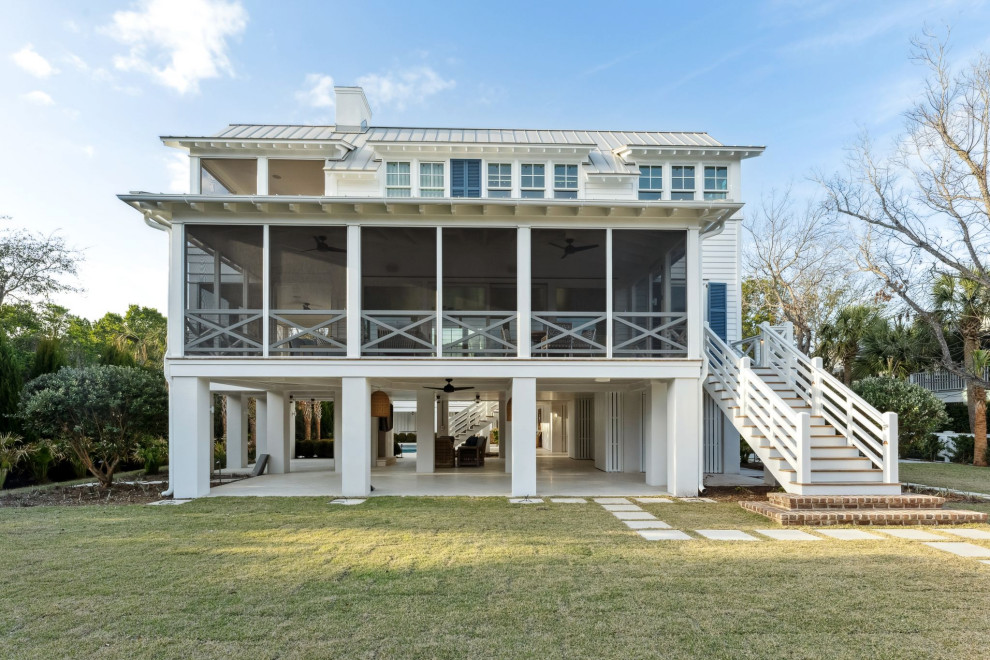 Historic Sea Cabins - Sullivan's Island beach house, highlighting the restored, existing historic sea cabin. Exterior is painted cedar lap siding with a hand-crimped metal roof in a light grey. The second story will offer ocean views