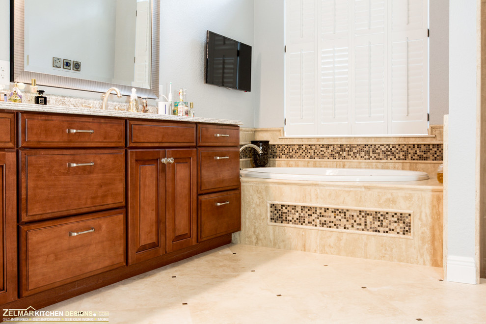 Large traditional master bathroom in Orlando with an undermount sink, raised-panel cabinets, medium wood cabinets, engineered quartz benchtops, a drop-in tub, an open shower, beige tile, stone tile and travertine floors.