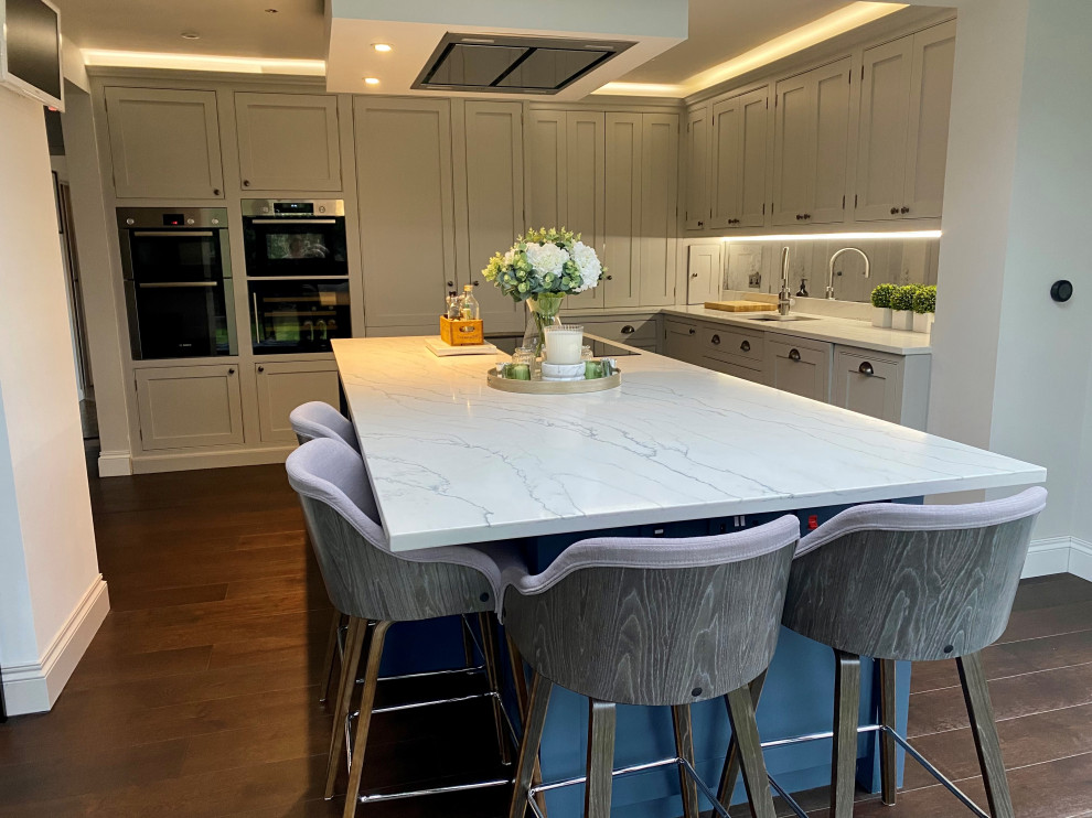Dark blue kitchen island with white and integrated hob