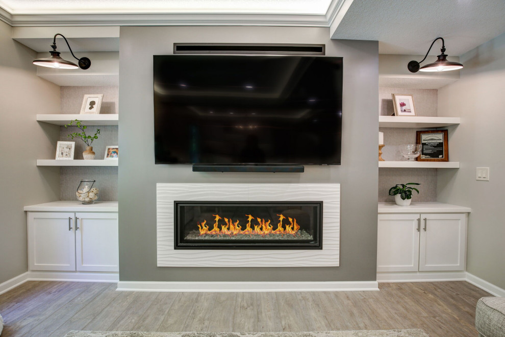 Design ideas for a large contemporary walk-out basement in Minneapolis with a home bar, grey walls, vinyl flooring, a standard fireplace, a tiled fireplace surround, grey floors, a drop ceiling and wallpapered walls.