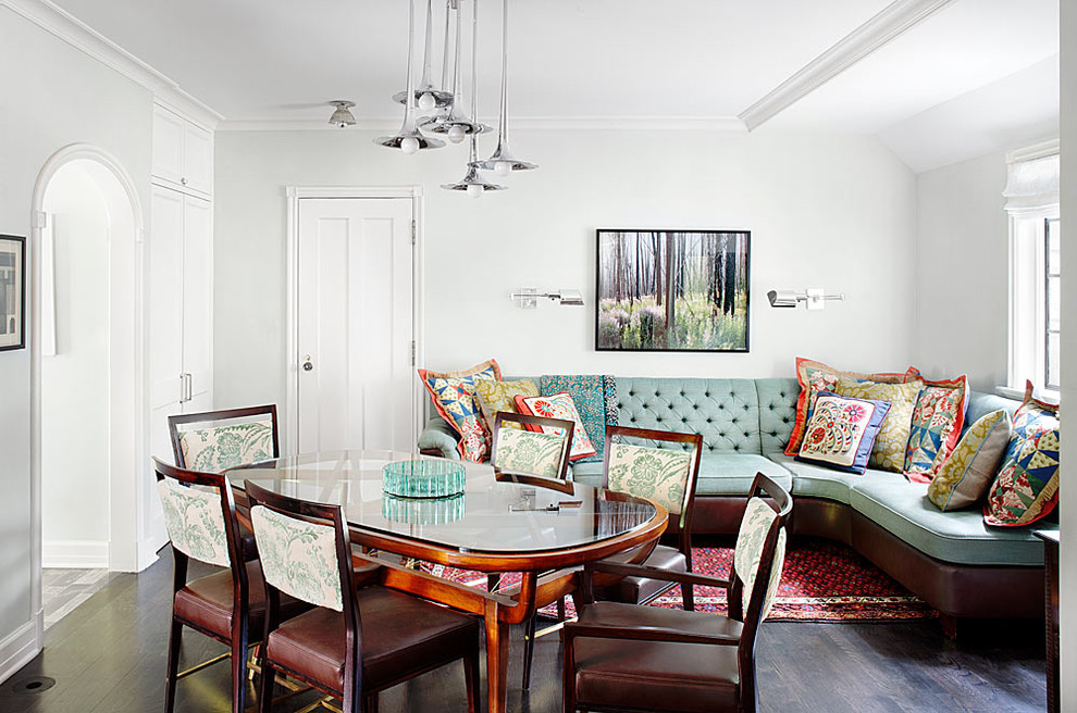 This is an example of a traditional dining room in Chicago with white walls and dark hardwood floors.