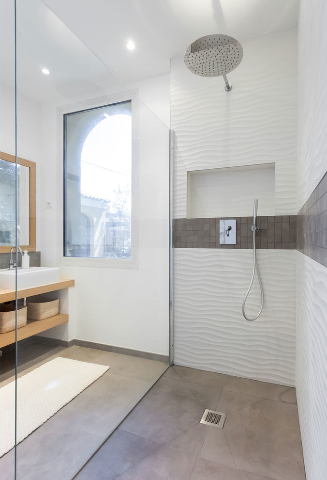 Large scandinavian master bathroom in Paris with light wood cabinets, a curbless shower, white tile, mosaic tile, white walls, ceramic floors, a drop-in sink, wood benchtops and grey floor.