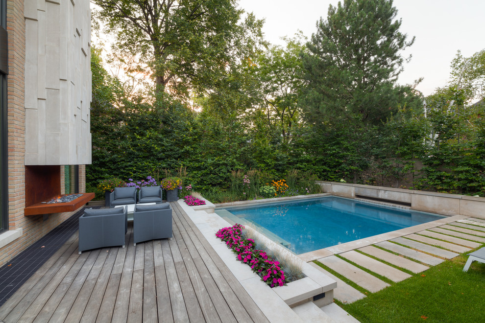 Inspiration for a small contemporary backyard rectangular pool in Other with a water feature and natural stone pavers.