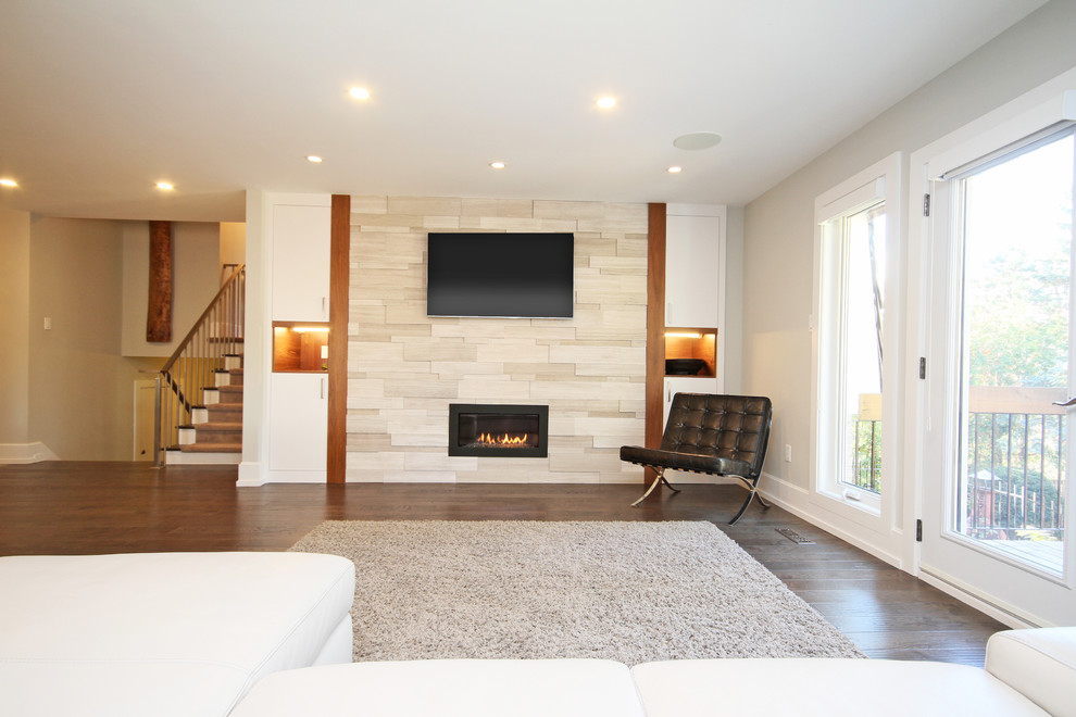 Design ideas for a contemporary family room in Toronto with white walls, medium hardwood floors and a wall-mounted tv.