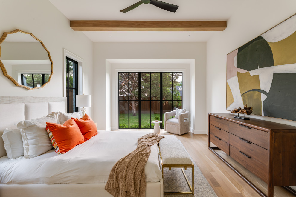 Transitional medium tone wood floor, brown floor and exposed beam bedroom photo in Dallas with white walls