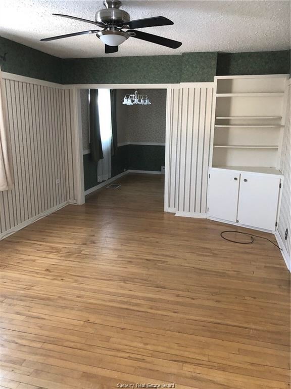 two adjoining rooms, chair rails at different heights.