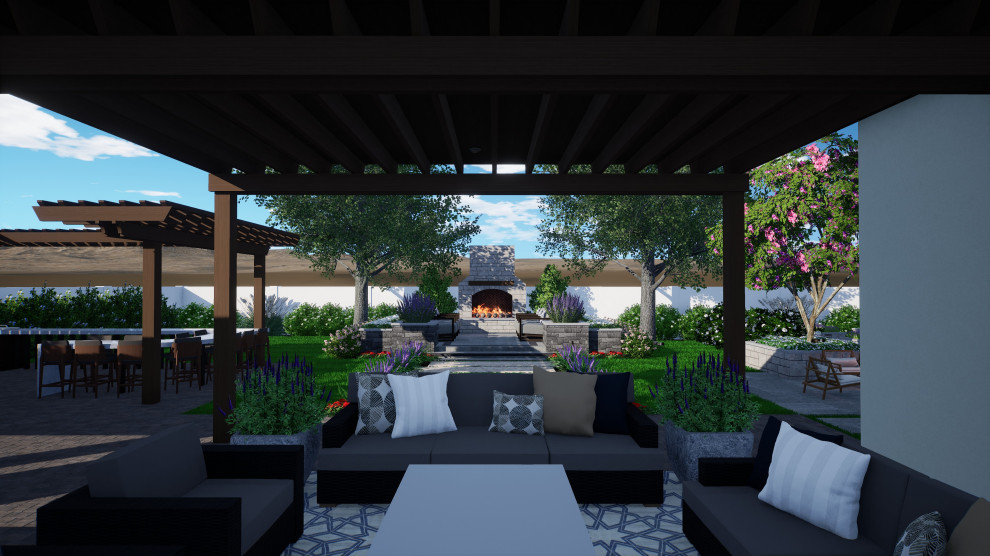 Traditional back patio in Phoenix with a fireplace, natural stone paving and an awning.