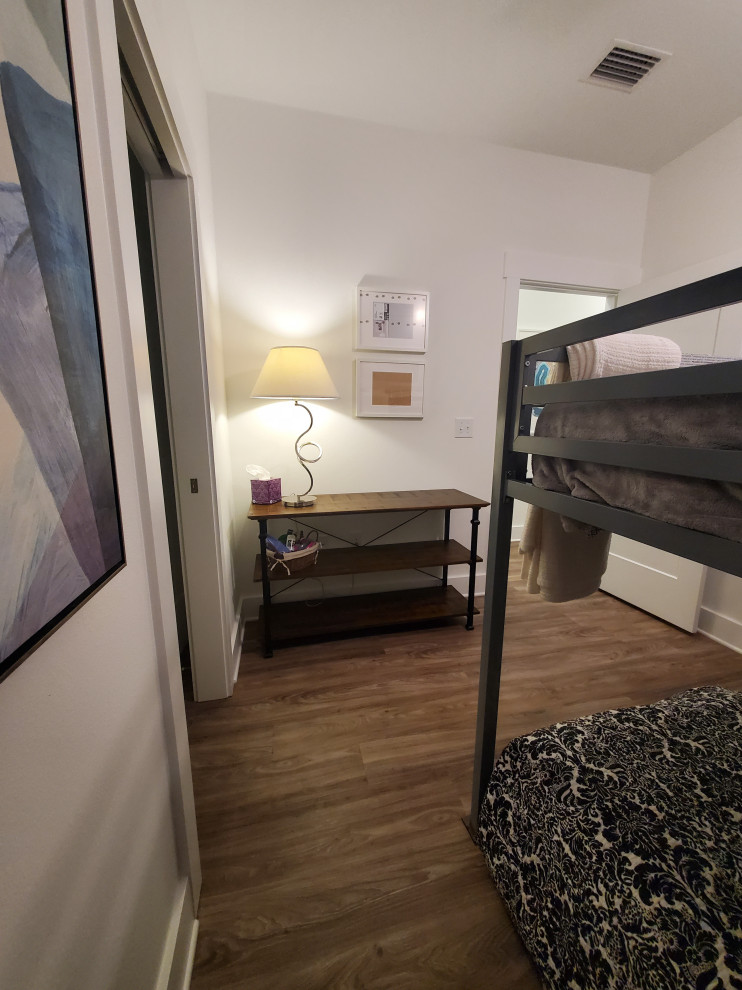 Mid-sized transitional guest vinyl floor and beige floor bedroom photo with white walls