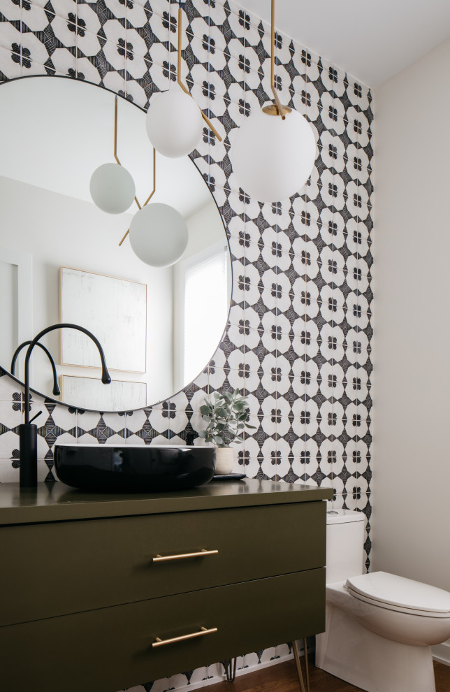 Contemporary powder room in Chicago with flat-panel cabinets, green cabinets, black and white tile, white walls, dark hardwood floors, a vessel sink, brown floor and green benchtops.