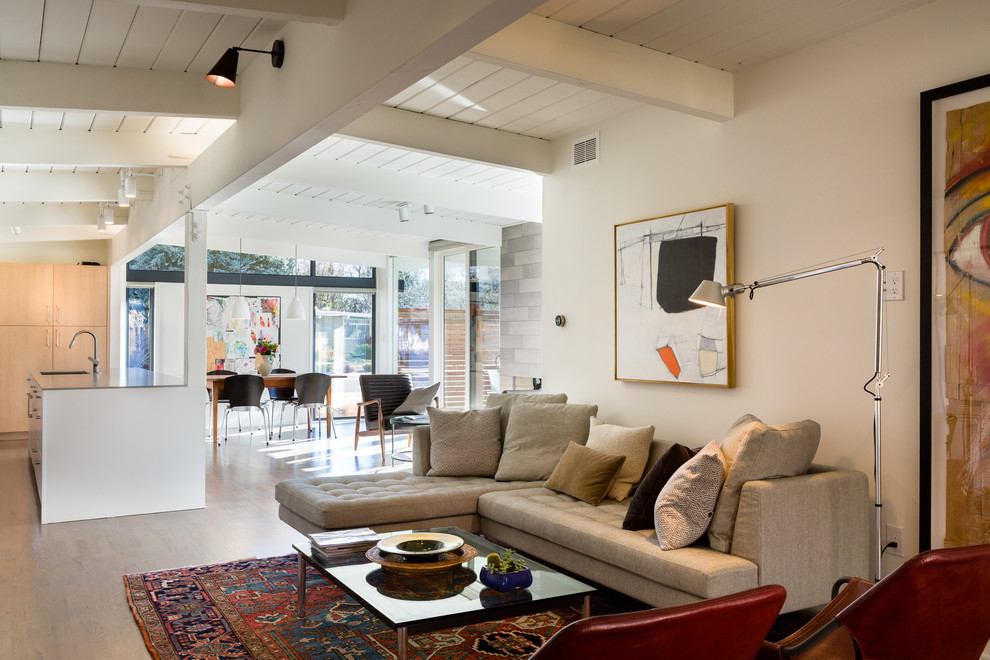 Photo of a midcentury open concept living room in Denver with medium hardwood floors.